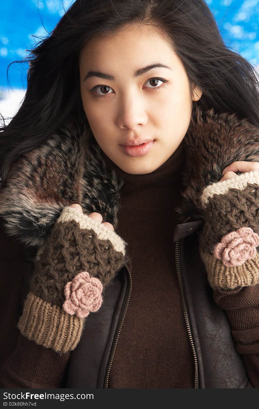 Young Woman Wearing Winter Clothes In Studio