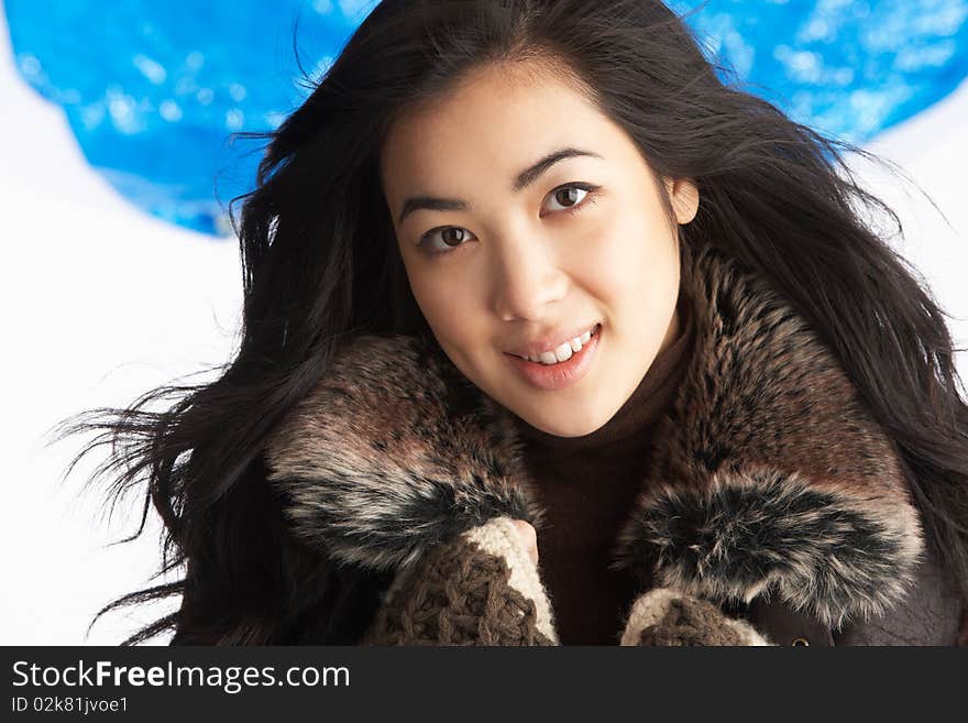 Young Woman Wearing Winter Clothes In Studio