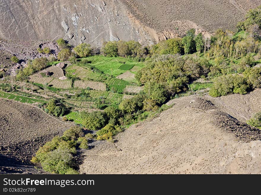 Agricultural fields in a valley surrounded by mountains. Agricultural fields in a valley surrounded by mountains