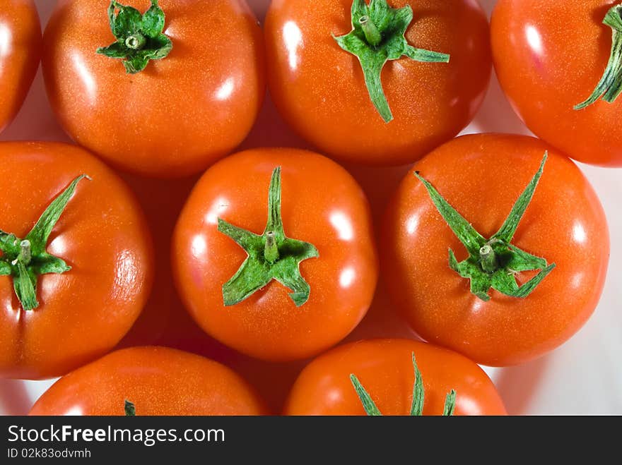 Much red tomato closeup on white background