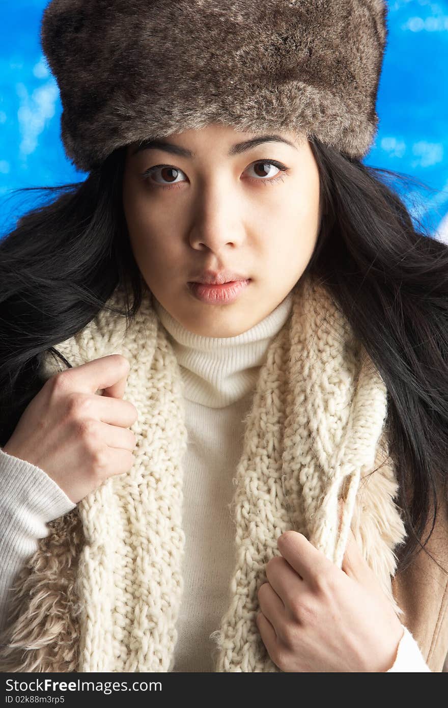 Young Woman Wearing Winter Clothes In Studio