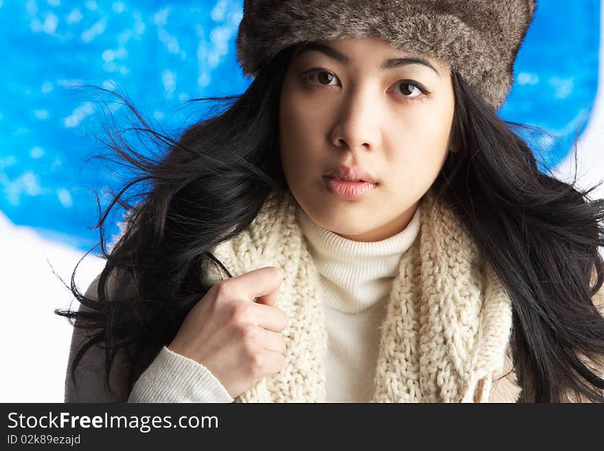 Woman Wearing Winter Clothes In Studio