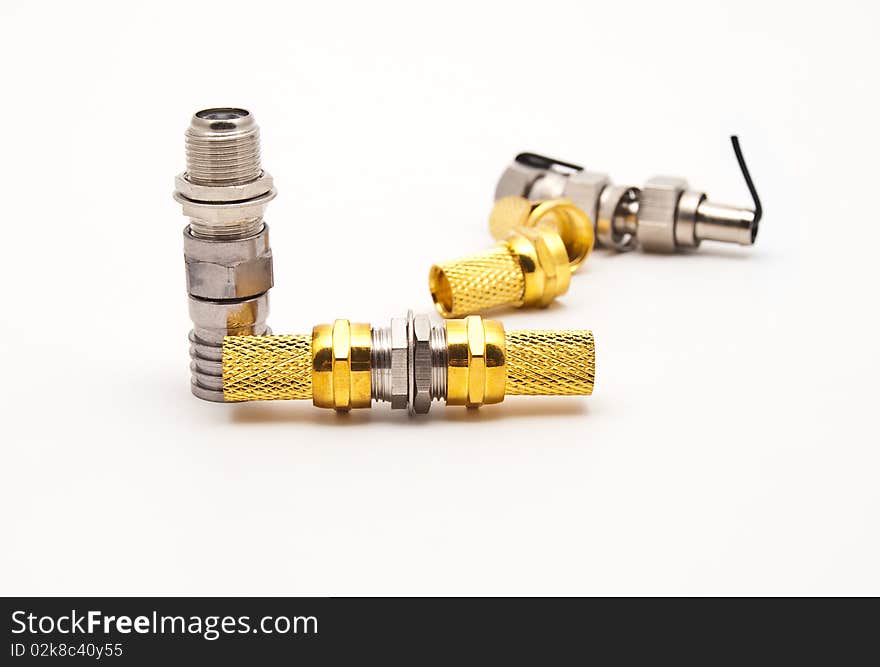 Gilded television connectors on a white background