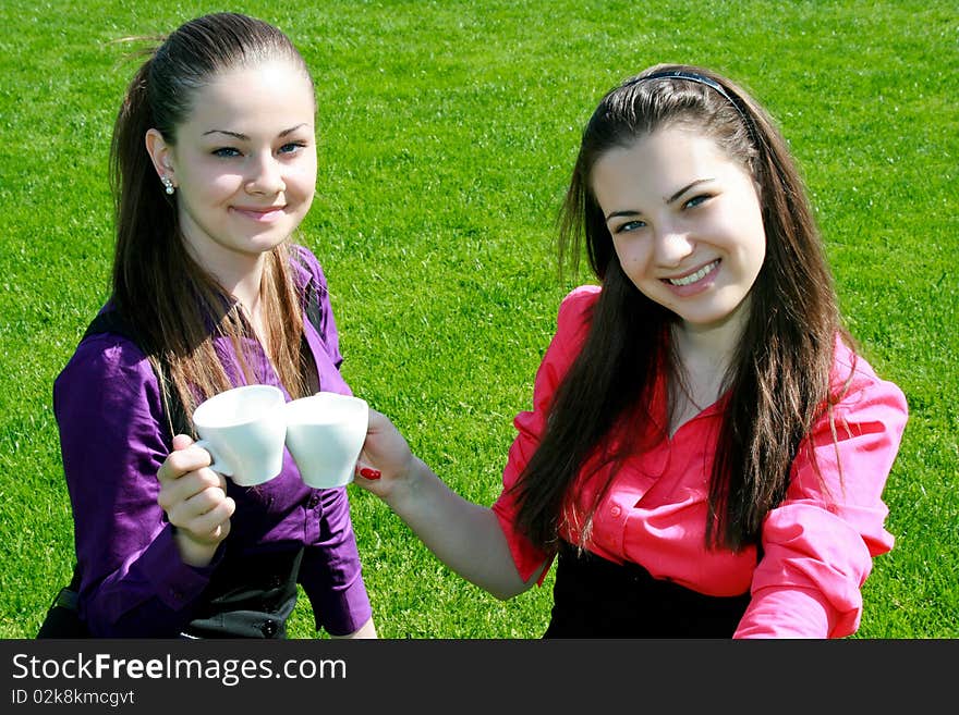 Young businesswomen drinking tea and talking