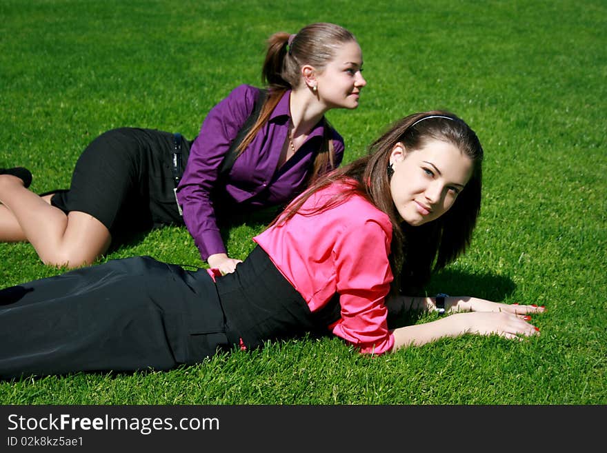 Young businesswomen relaxing on the grass