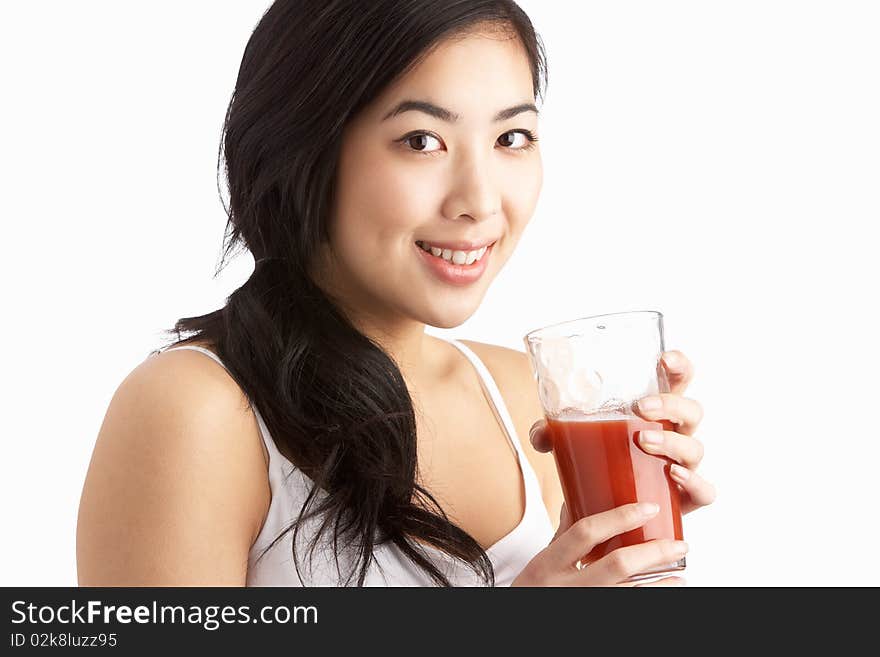 Young Woman Enjoying Healthy Drink In Studio At Camera