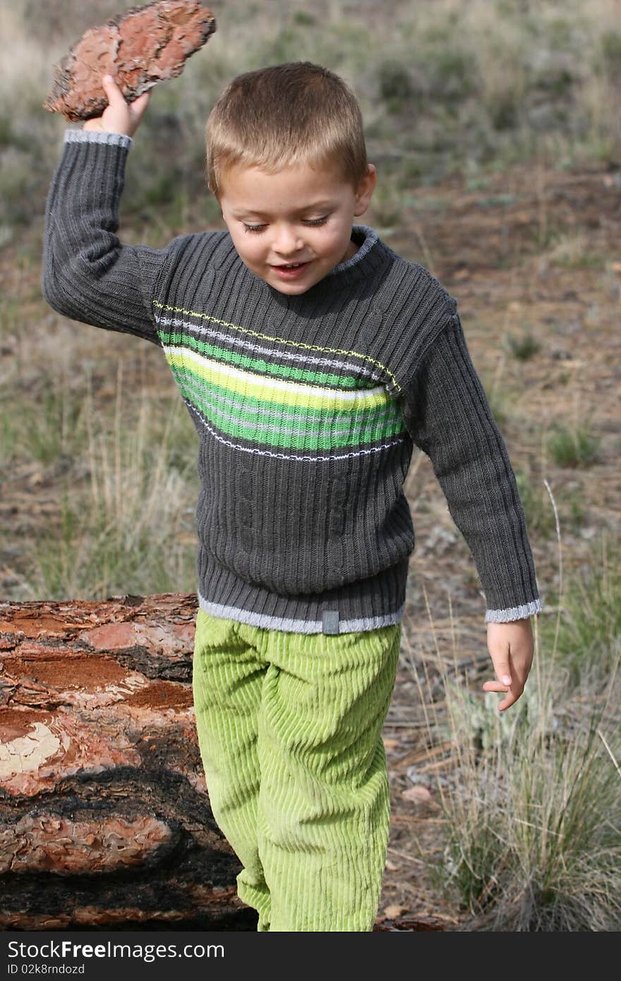 Beautiful blond boy playing outdoors on a spring day. Beautiful blond boy playing outdoors on a spring day