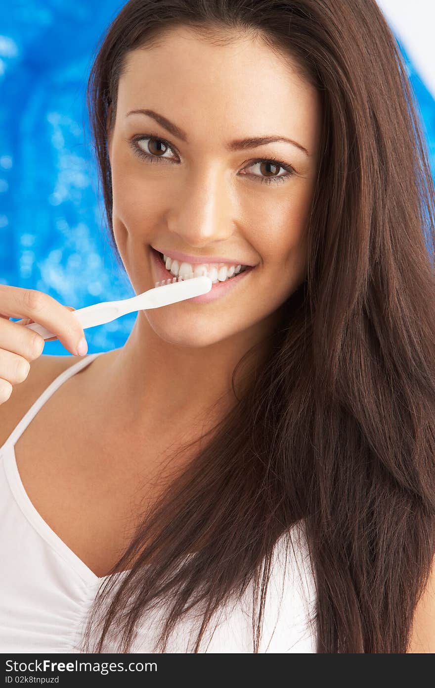 Young Woman Brushing Teeth In Studio