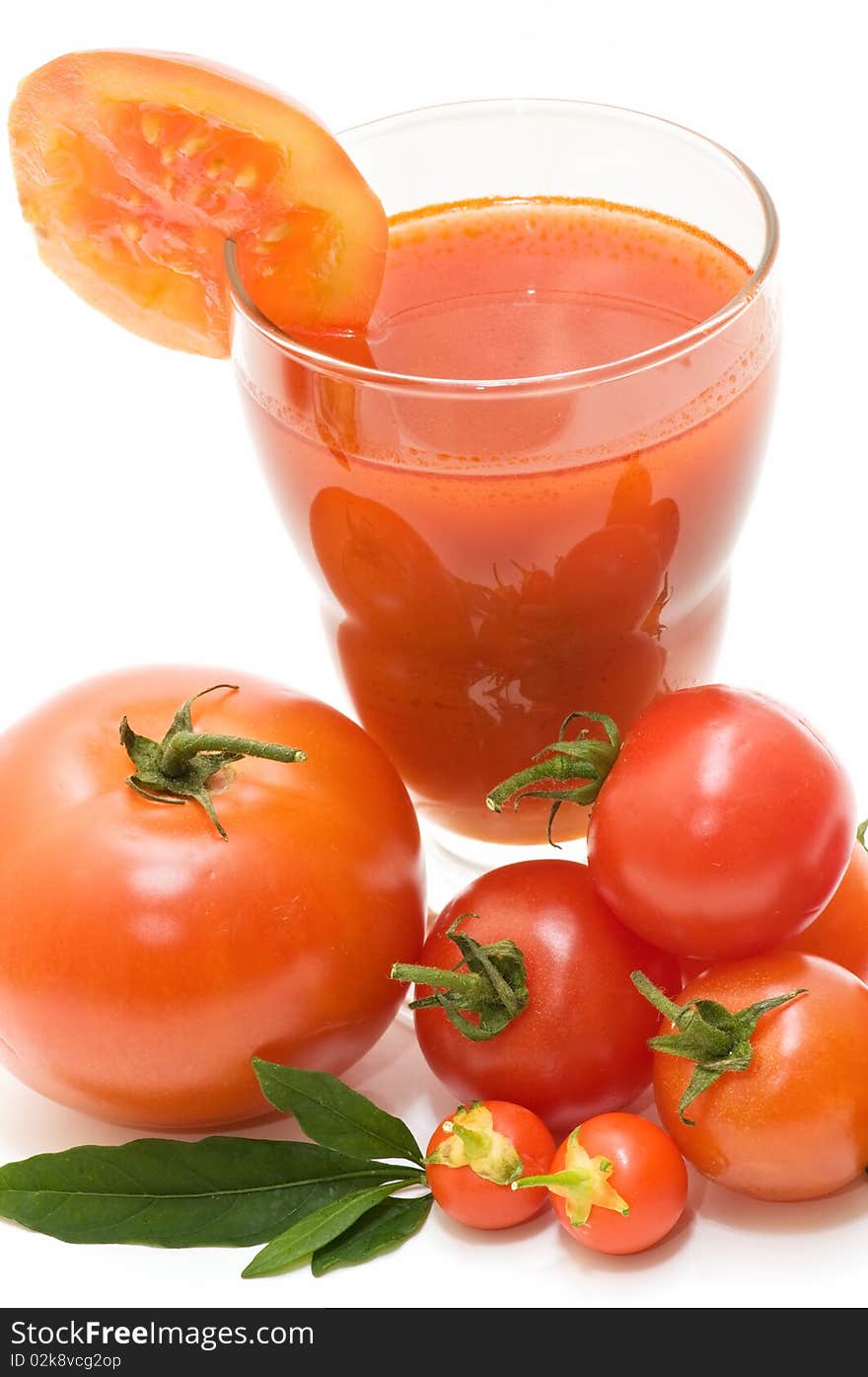 Tomatoes and tomato juice on white background