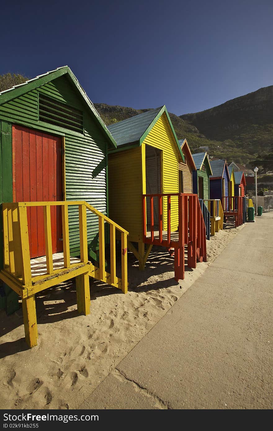 Colourful wooden changing cabins at the beach. St James beach, Cape Town. Colourful wooden changing cabins at the beach. St James beach, Cape Town.