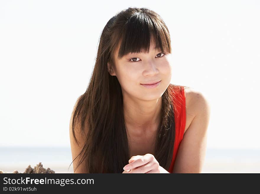 Young Woman Relaxing On Beach