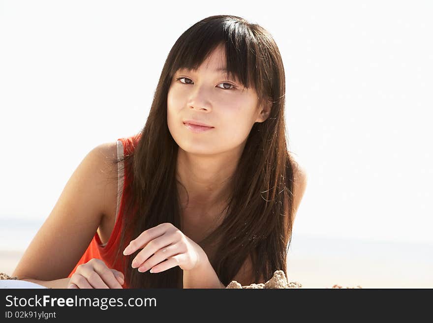 Young Woman Relaxing On Beach