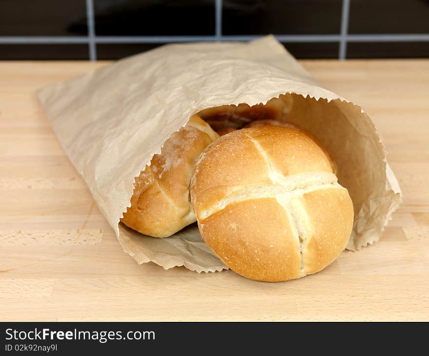 Fresh bread rolls isolated on a kitchen bench