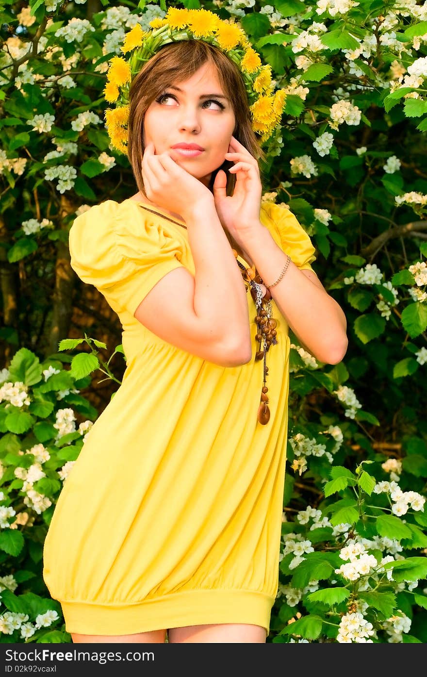 Thoughtful young woman in dandelion garland. Thoughtful young woman in dandelion garland