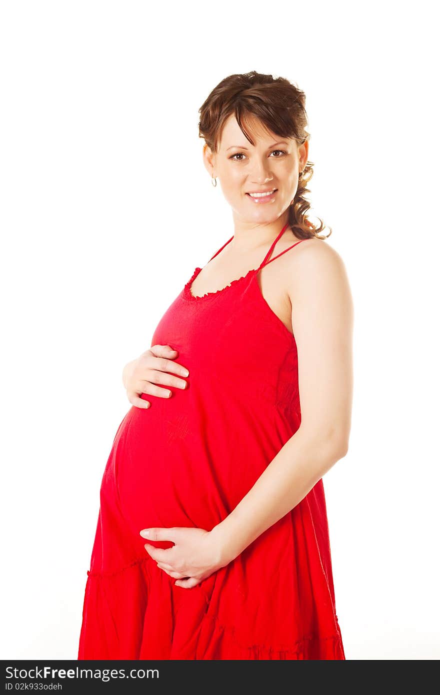 Beautiful young brunette pregnant woman wearing a red dress. Beautiful young brunette pregnant woman wearing a red dress