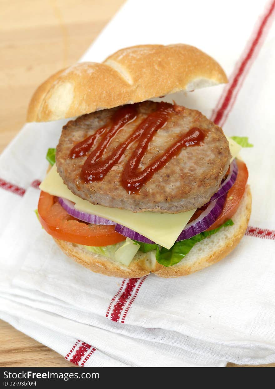 A freshly made American style hamburger with sauce