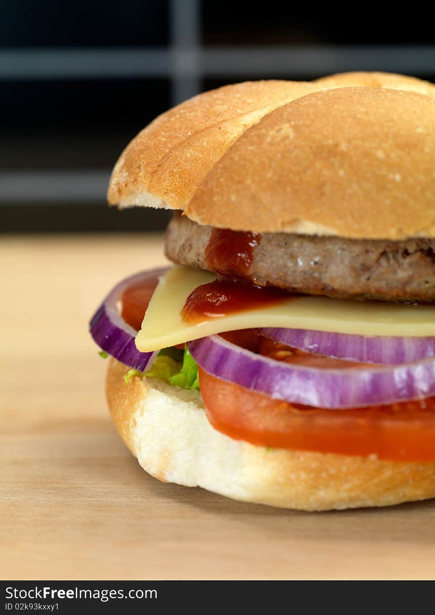 A freshly made American style hamburger with sauce