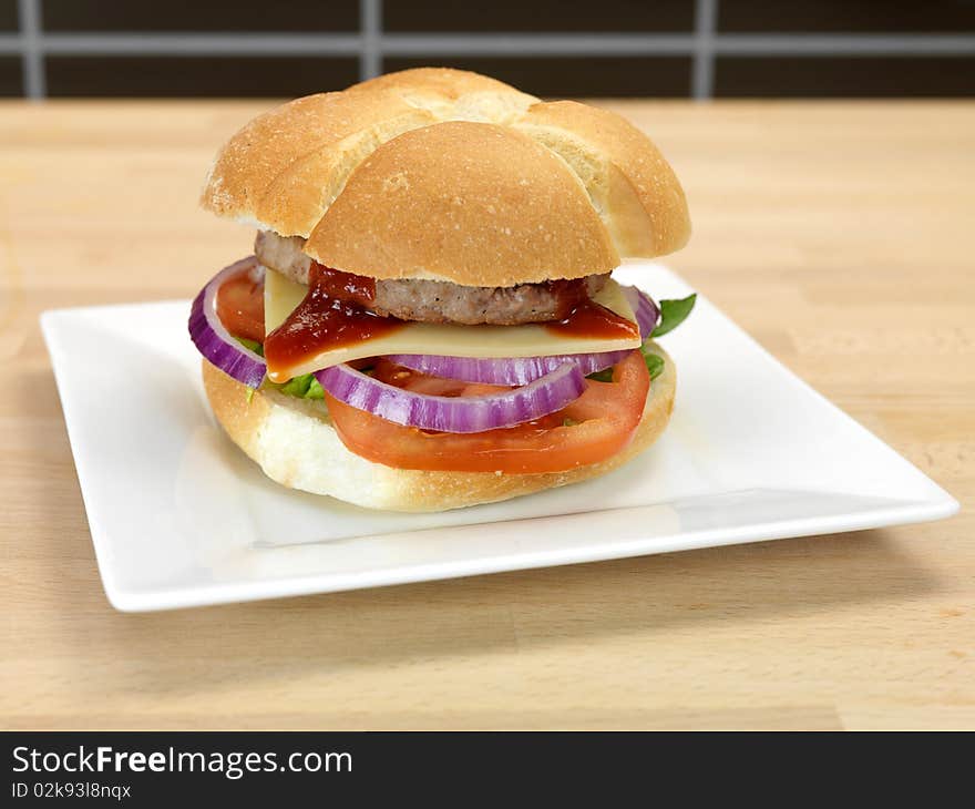 A freshly made American style hamburger with sauce