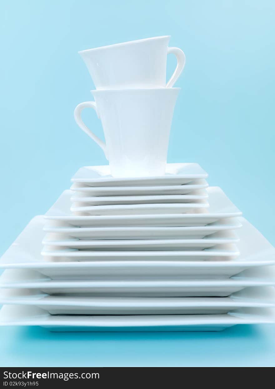 Plates and cutlery isolated against a blue background