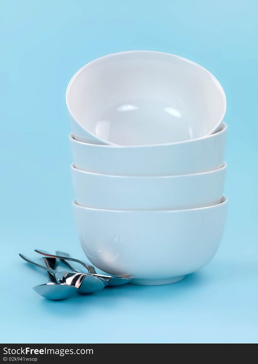 Plates and cutlery isolated against a blue background