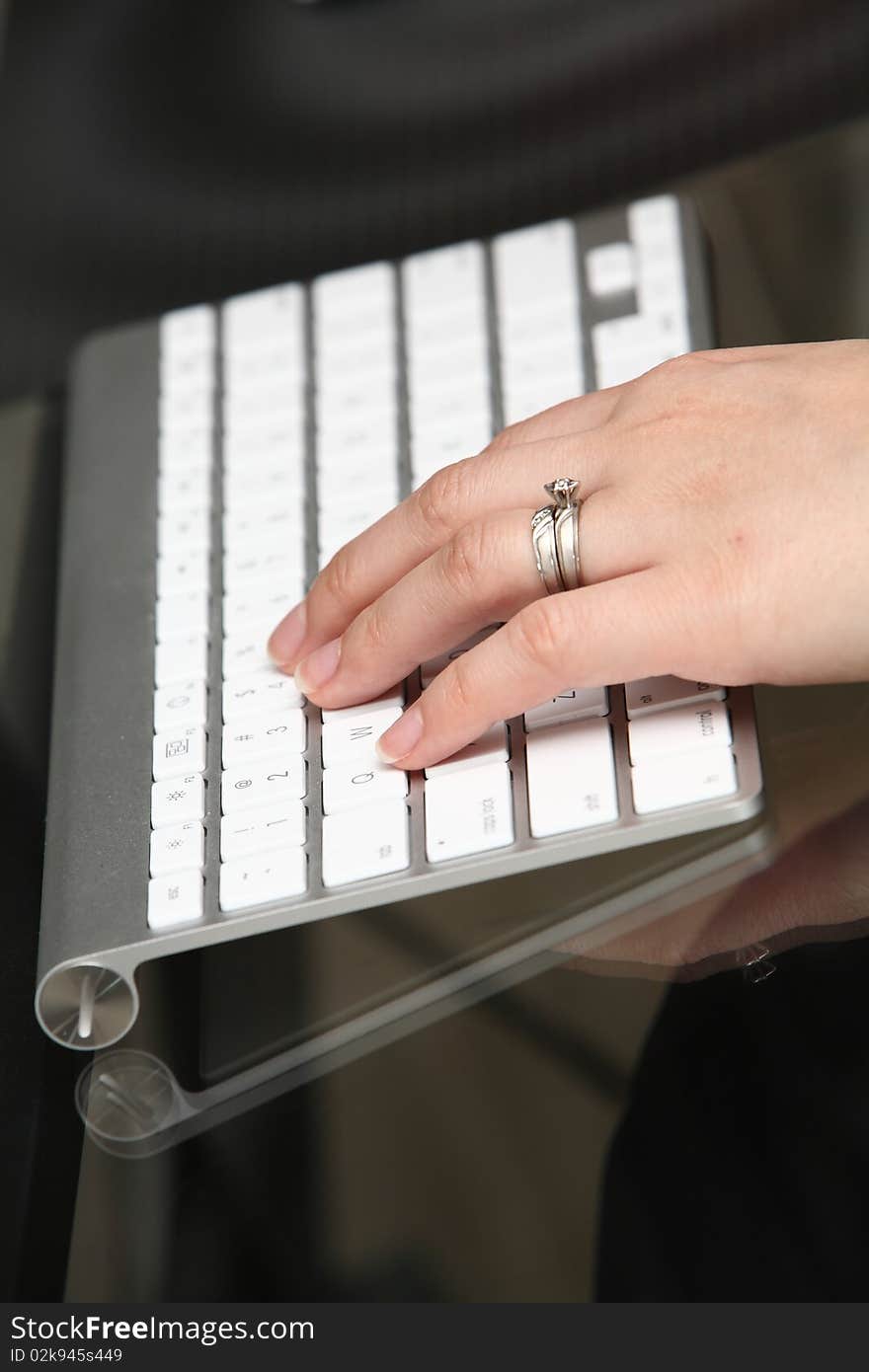 One person working on the computer, close-up image. One person working on the computer, close-up image