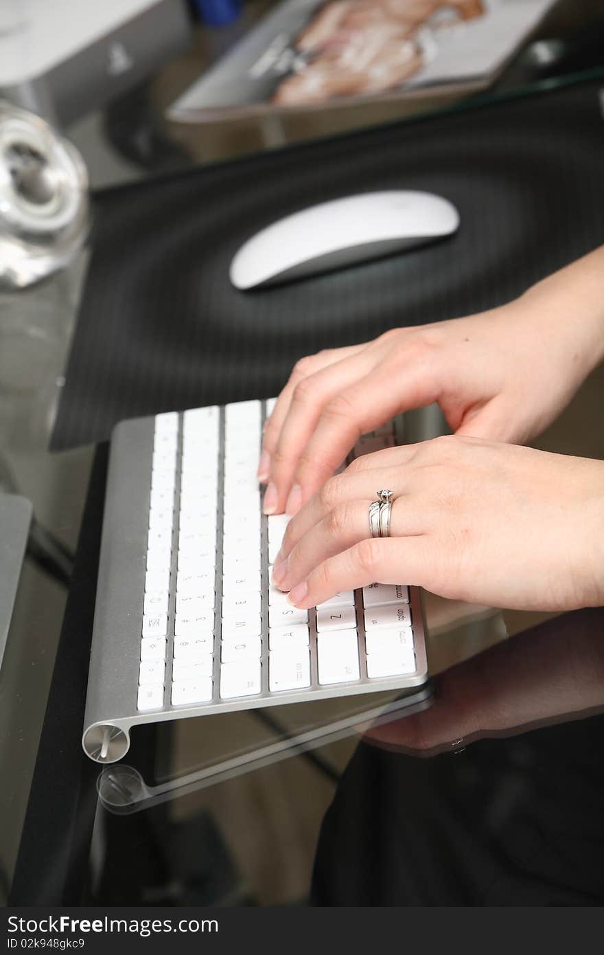 One person working on the computer, close-up image. One person working on the computer, close-up image