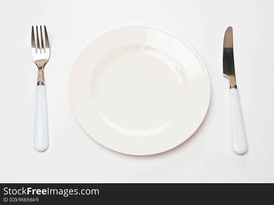 Set of kitchen object. The spoon, a fork separately on a grey background. Set of kitchen object. The spoon, a fork separately on a grey background.