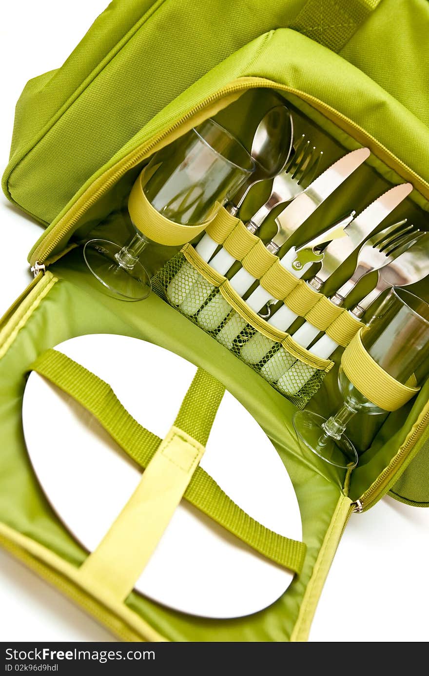 Opened picnic bag with tableware on white background