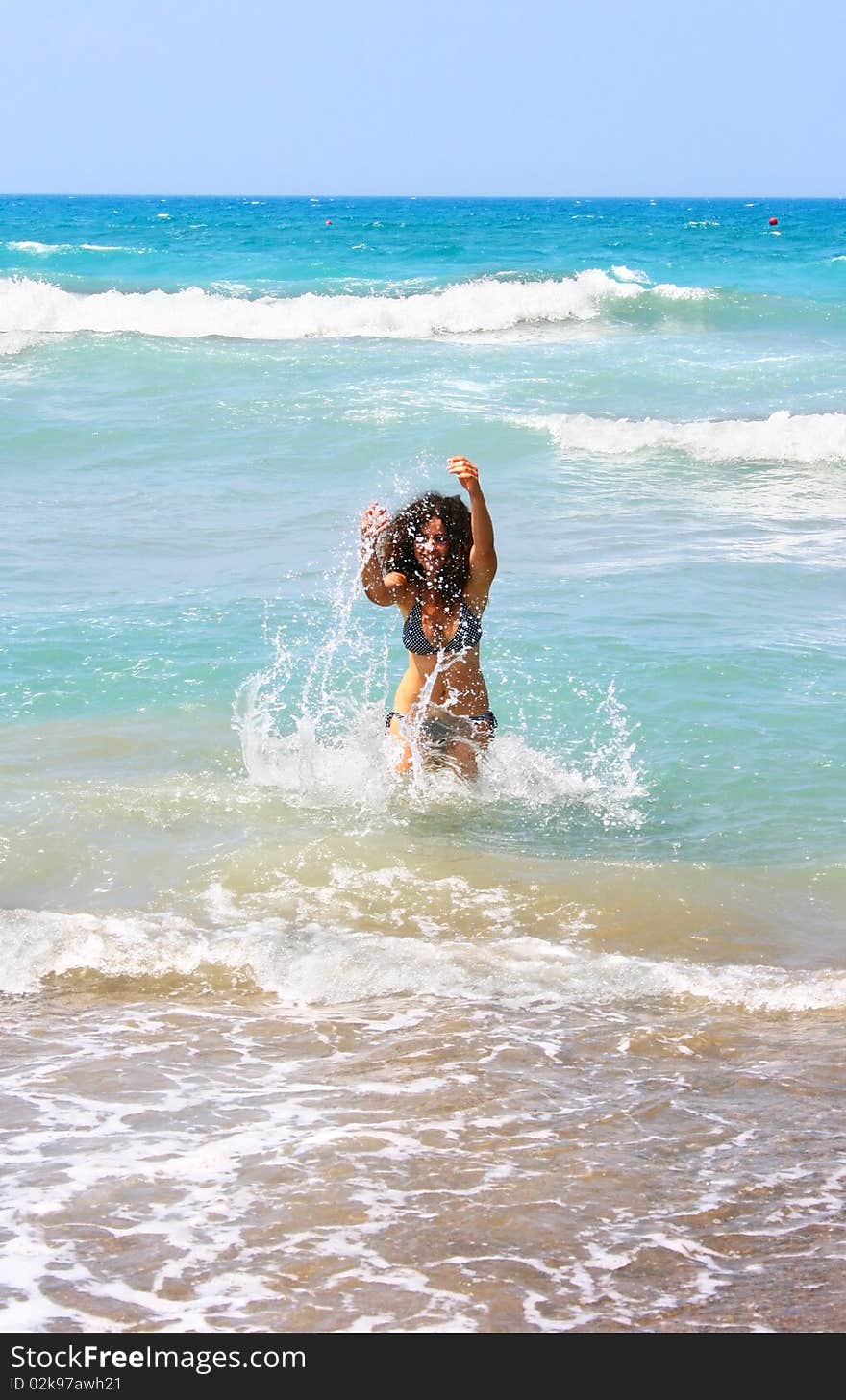 Pretty brunette girl in blue sea. Pretty brunette girl in blue sea.