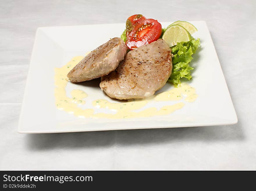 Fish meat steak with tomatoes. Fish meat steak with tomatoes