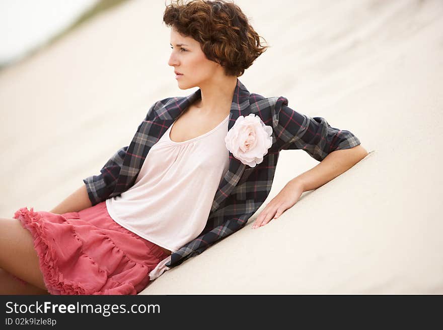 Attractive Young Woman Standing Amongst Sandunes