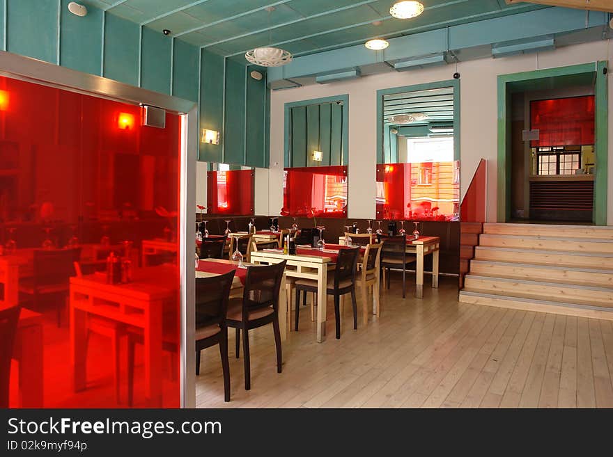 View of restaurant with tables, chairs and steps