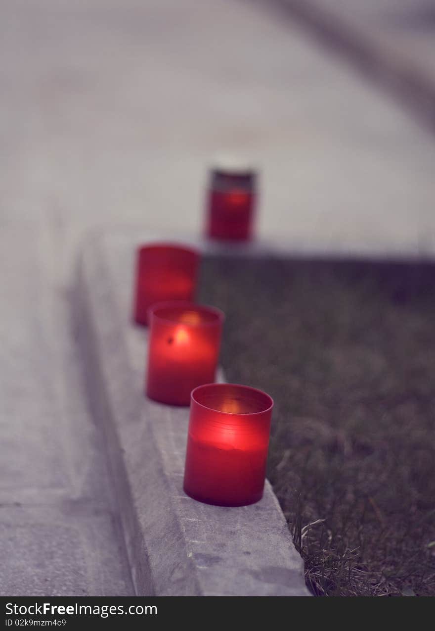 Set of red candles on the street.