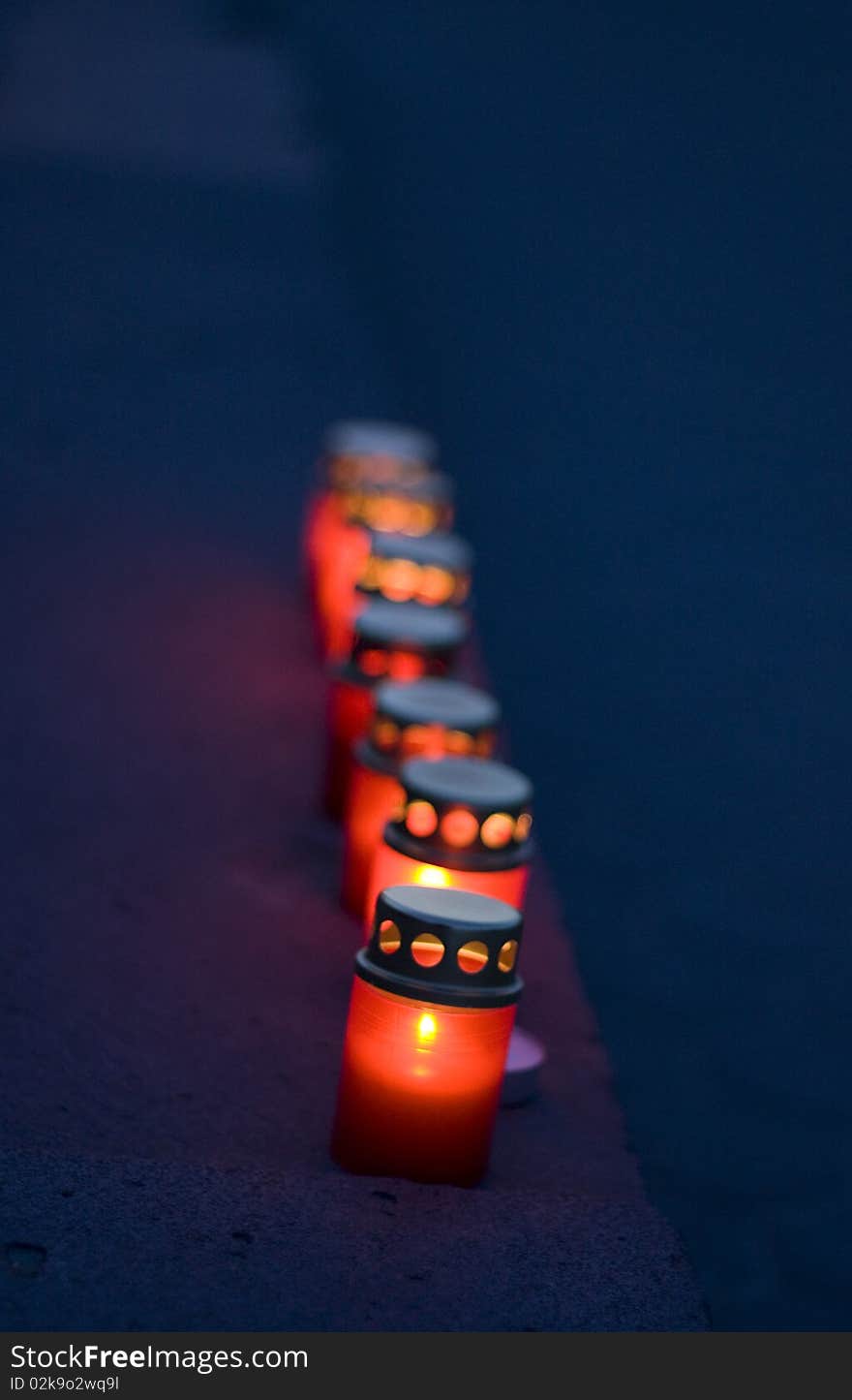 Set of red candles on the street.