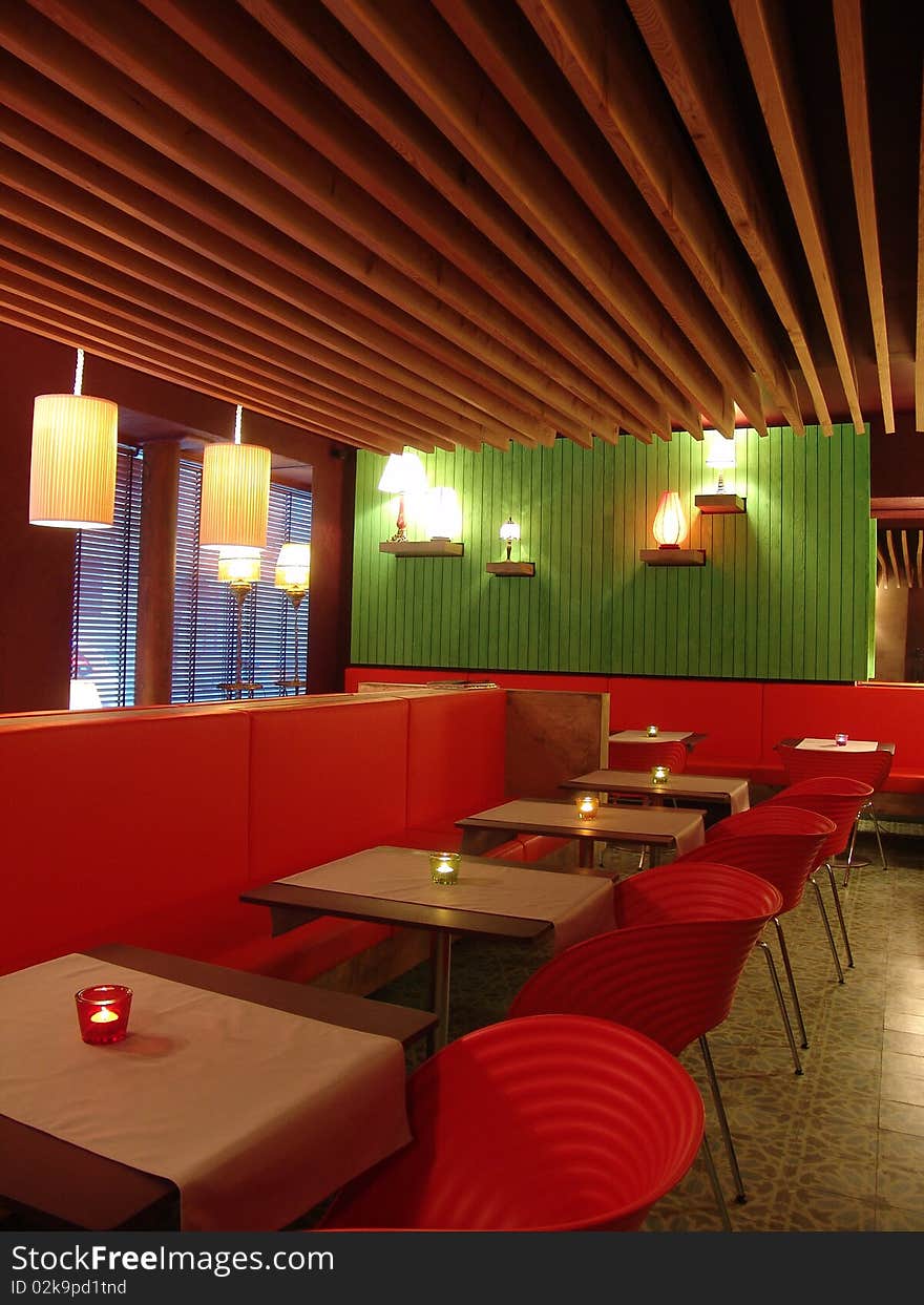 View of restaurant in modern style with red chairs