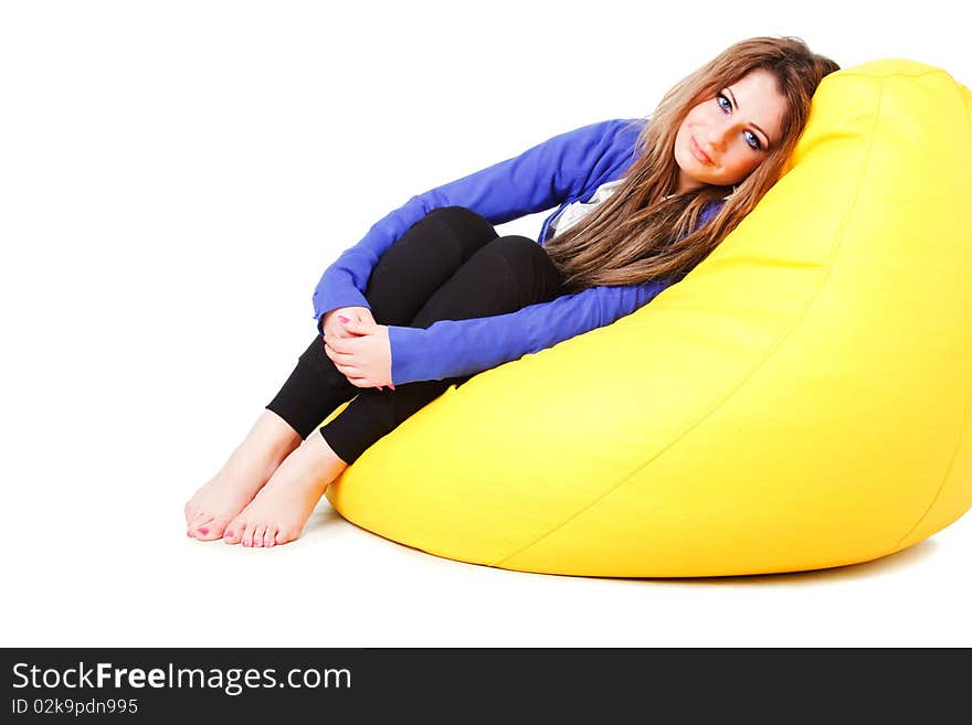 Picture of a attractive young girl in blue on armchair. Isolated on white. Picture of a attractive young girl in blue on armchair. Isolated on white.