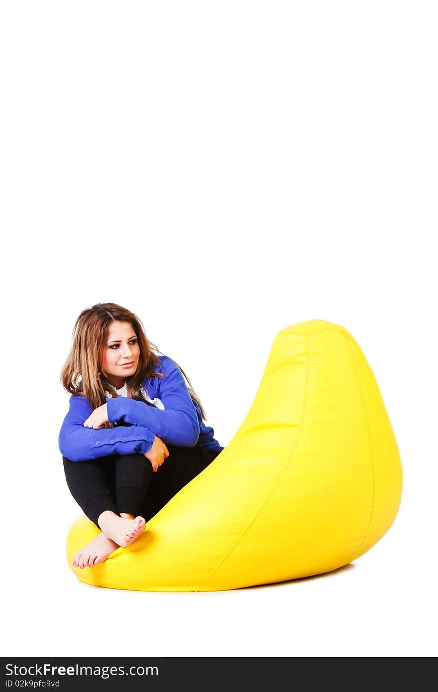 Picture of a attractive young girl in blue on armchair. Isolated on white. Picture of a attractive young girl in blue on armchair. Isolated on white.