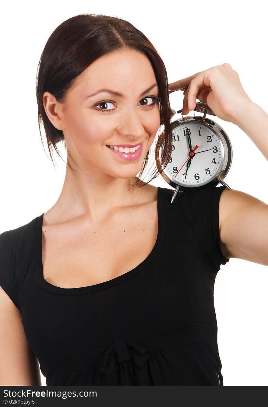 Beautiful young woman listening to the ticking of alarm clock. Beautiful young woman listening to the ticking of alarm clock