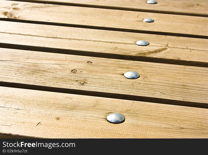 Wooden floor with grey nails as background