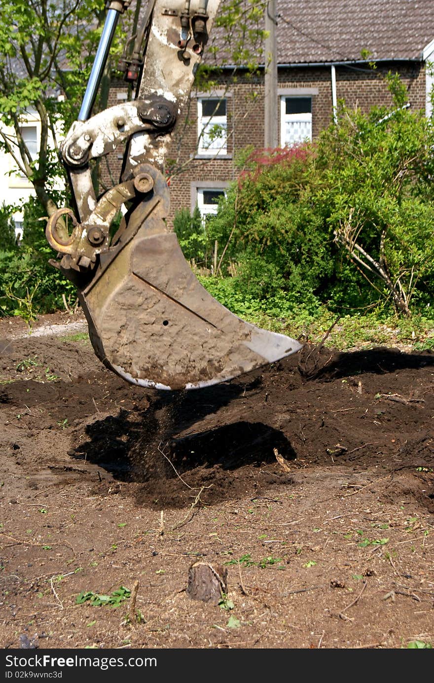 An excavator working in a garden