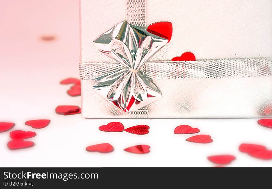 Silver gift box with red hearts