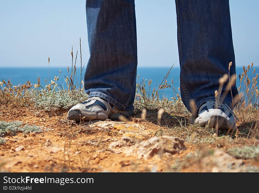 Feet in slippers about the sea