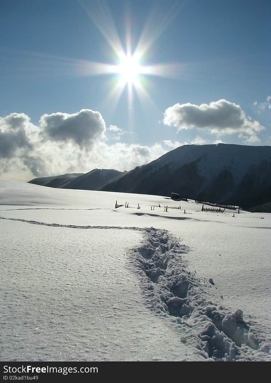 Sunny day in the Carpathian Mts. Footprints in the snowbound mountains. Sunny day in the Carpathian Mts. Footprints in the snowbound mountains