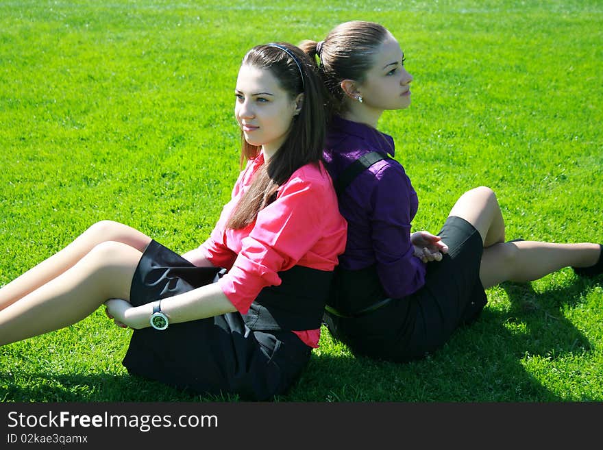 Young businesswomen relaxing on the grass