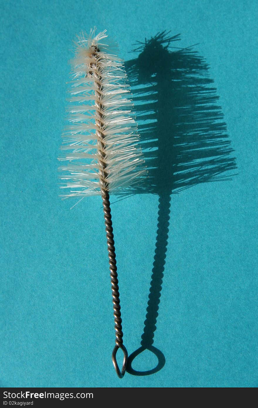 Small brush on a blue background. Small brush on a blue background