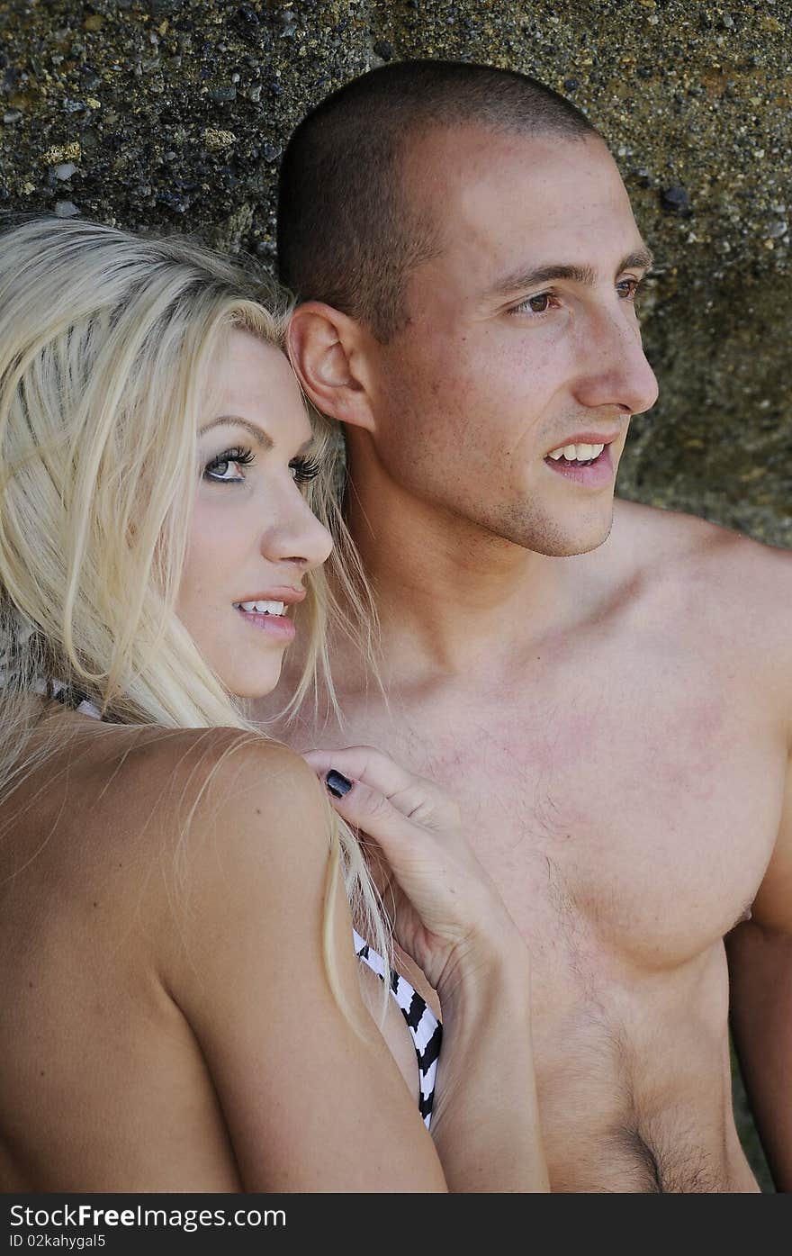 Young attractive couple enjoying an afternoon at the beach. Young attractive couple enjoying an afternoon at the beach