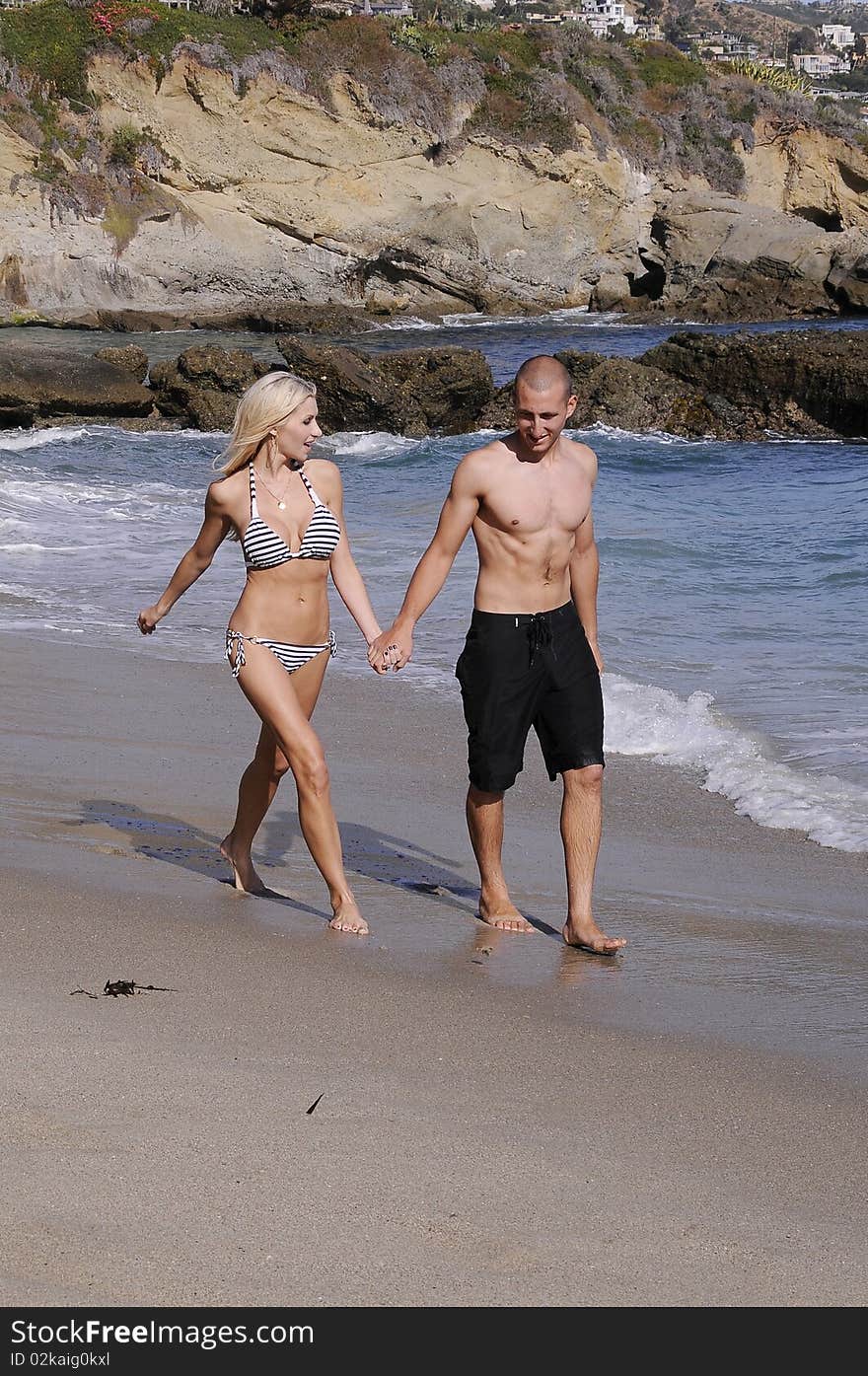 Young attractive couple enjoying an afternoon at the beach. Young attractive couple enjoying an afternoon at the beach