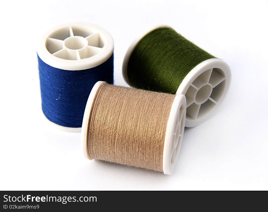 Colourful threads on white background