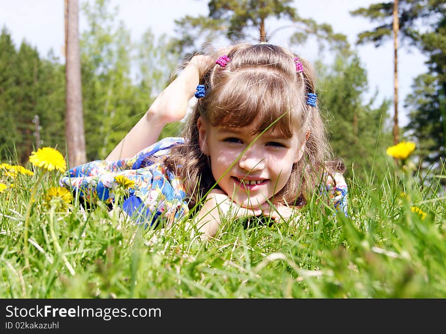 The girl lays in a grass