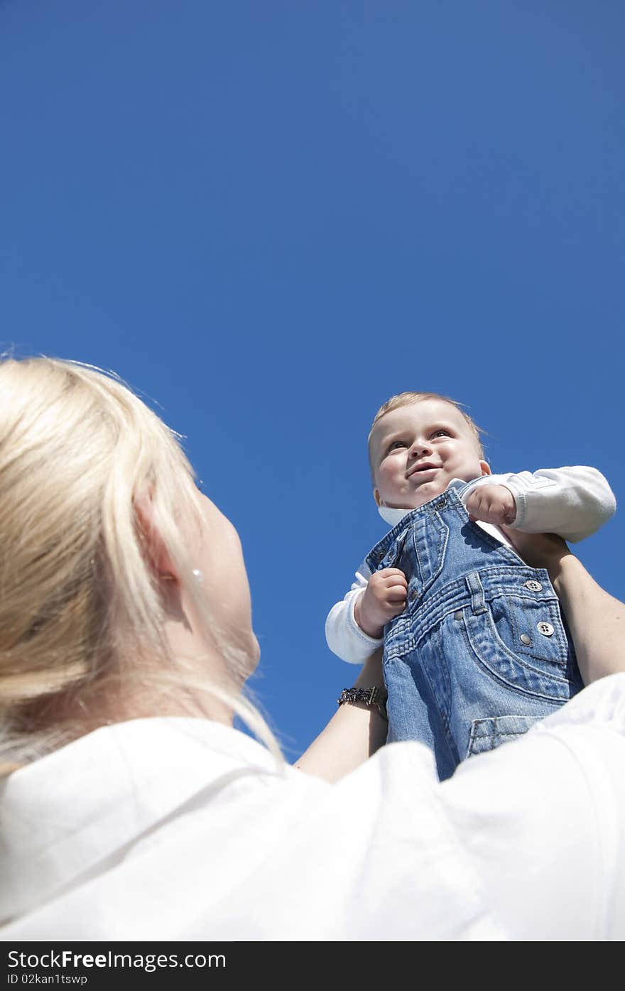 Little boy at the hands of his mother, paternal care. Little boy at the hands of his mother, paternal care